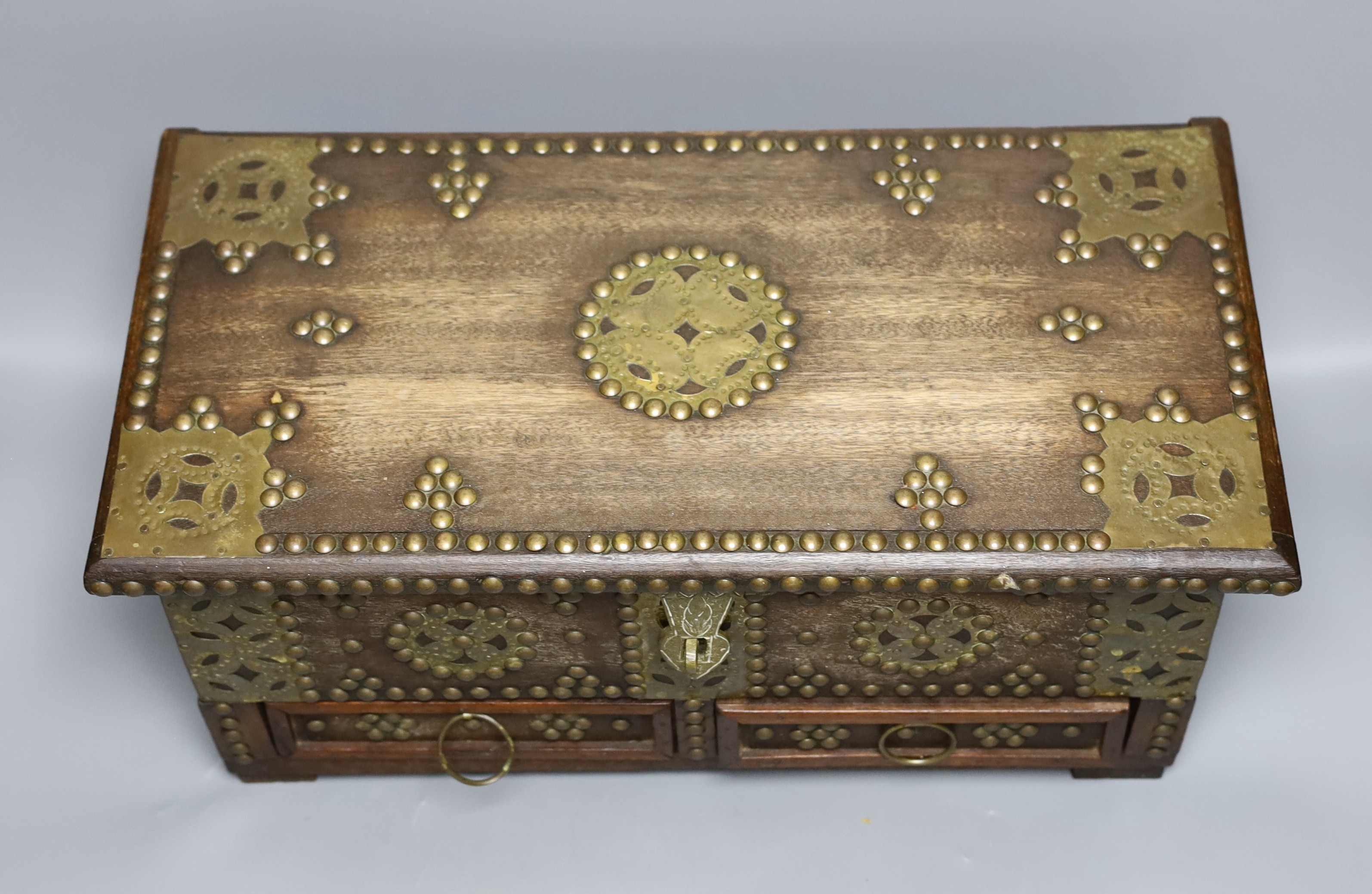 An Indian brass studded and mounted box, 45cms wide x 21cms high